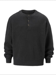 Dark gray ribbed knit henley sweater with button placket and oversized fit.