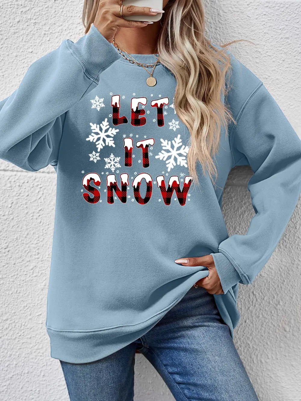Misty Blue graphic crewneck sweatshirt with "Let It Snow" text and snowflakes.