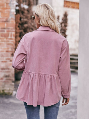 Pink corduroy peplum shirt jacket with buttoned cuffs and a ruffled hem.