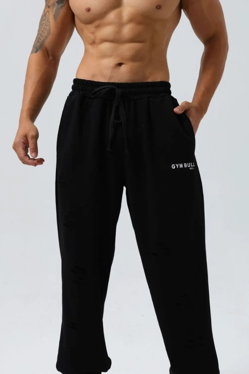 Black distressed jogger trousers with drawstring waist and Gym Bull logo.