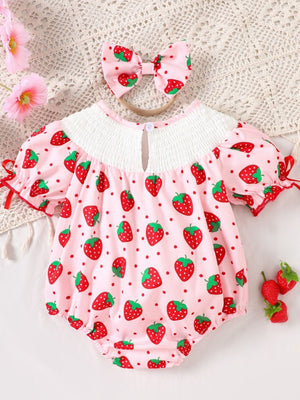 Baby pink strawberry print smocked one-piece with puff sleeves and matching headband.