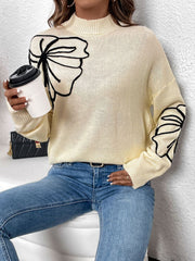 Pastel yellow acrylic knit sweater with embroidered floral motifs on the chest and sleeves.