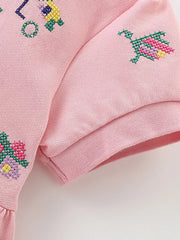Pink cotton blend baby dress with embroidered flowers and a polo collar detail.