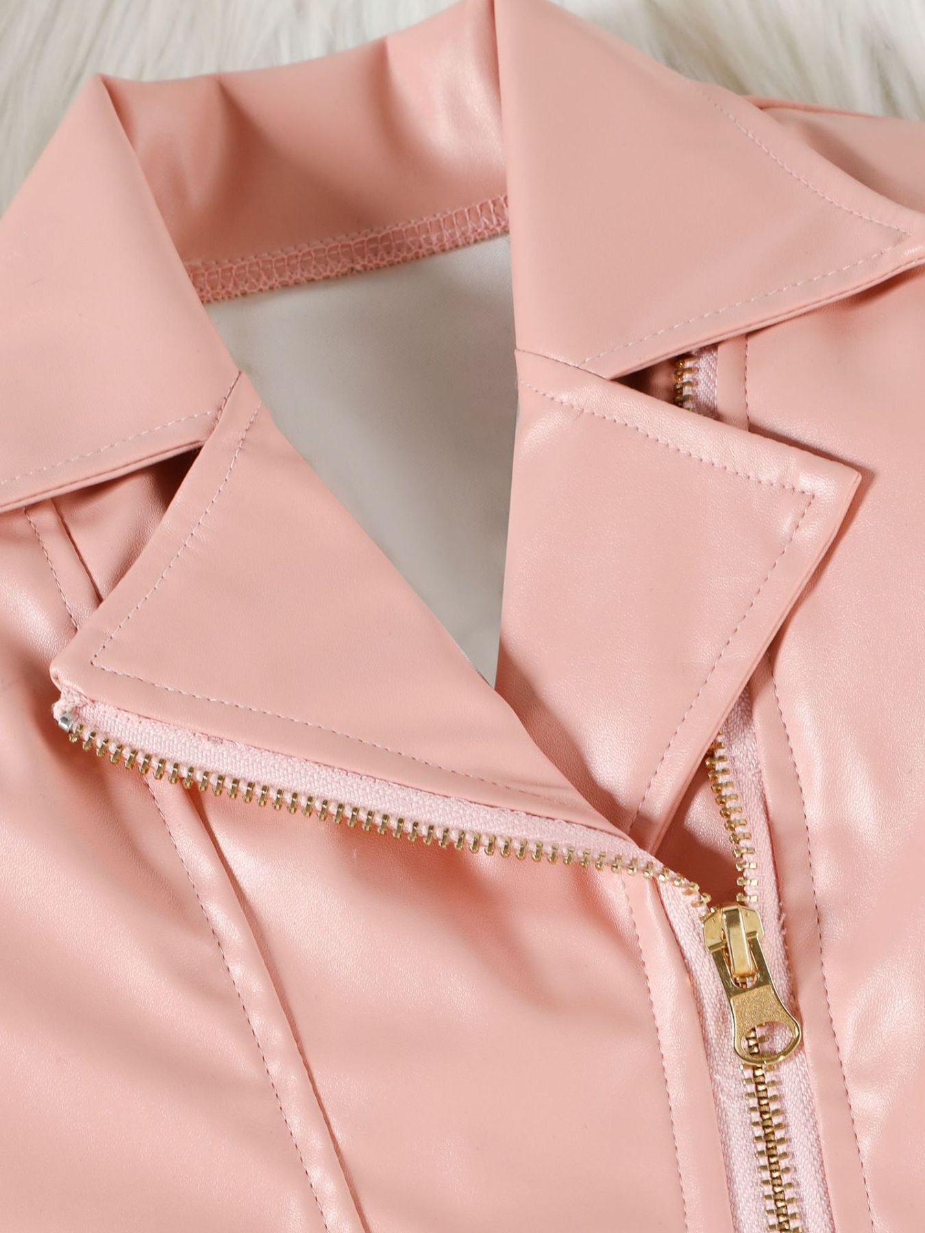 Pink faux leather baby jacket with gold zipper detail and lapel.