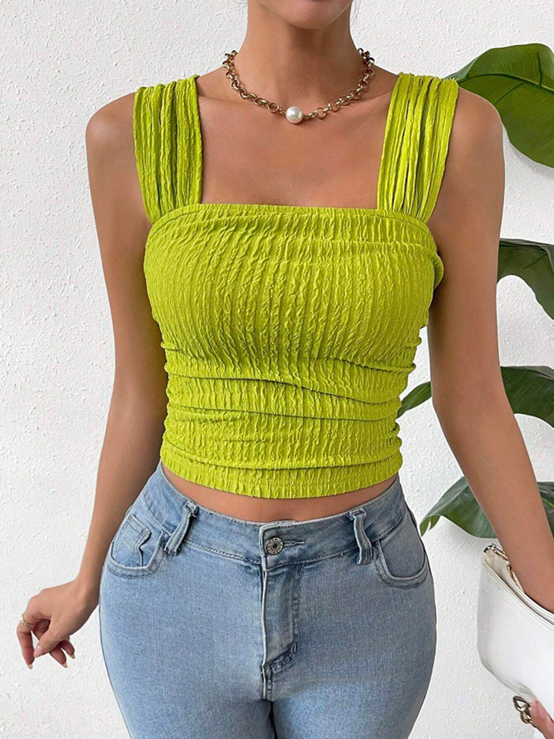 Textured crinkle strap crop top in yellow-green with ruched detail.