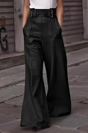 Black leather wide-leg pants with a buckle belt and pleats