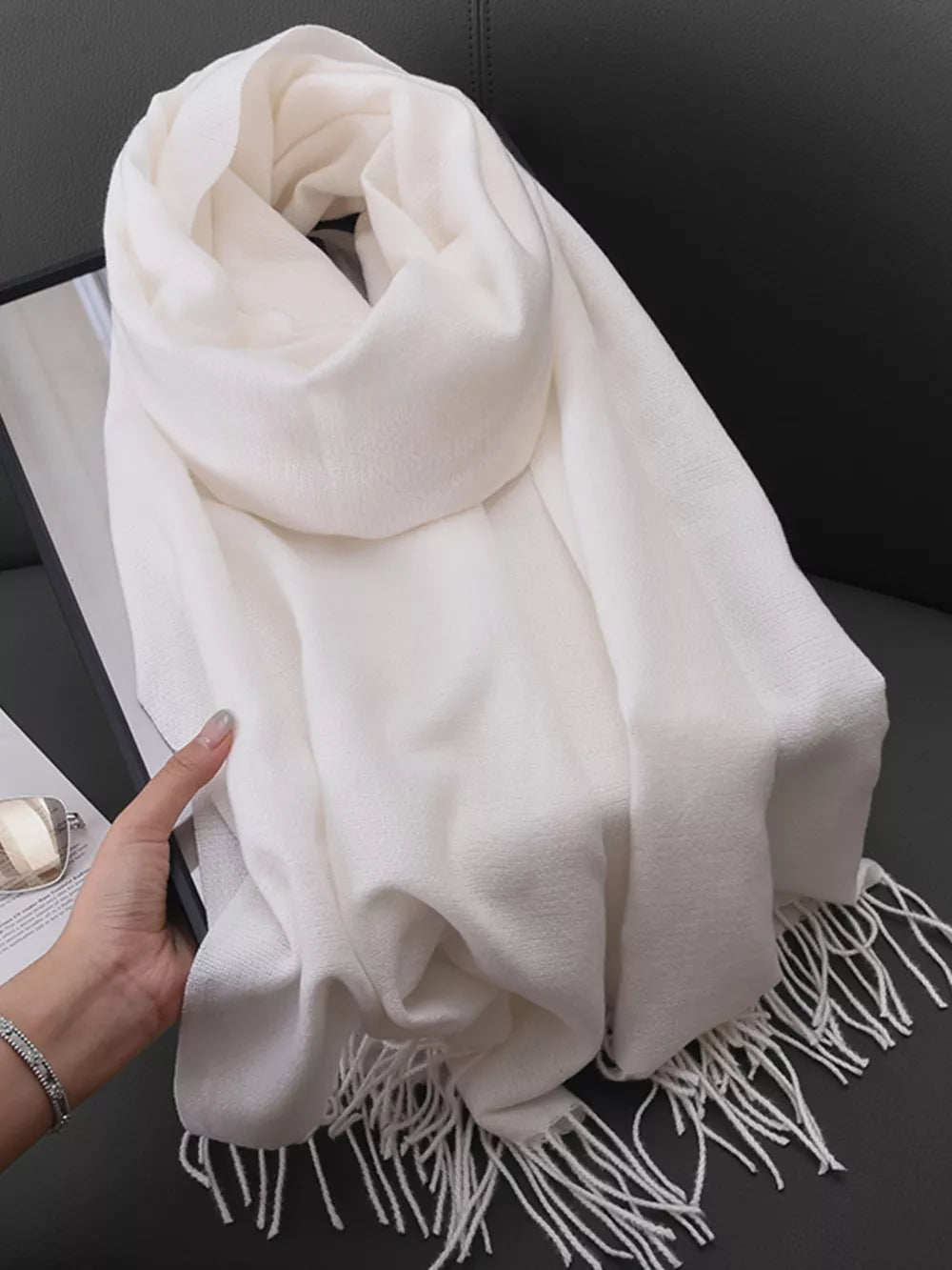 White fringe scarf with a soft texture, perfect for versatile styling.