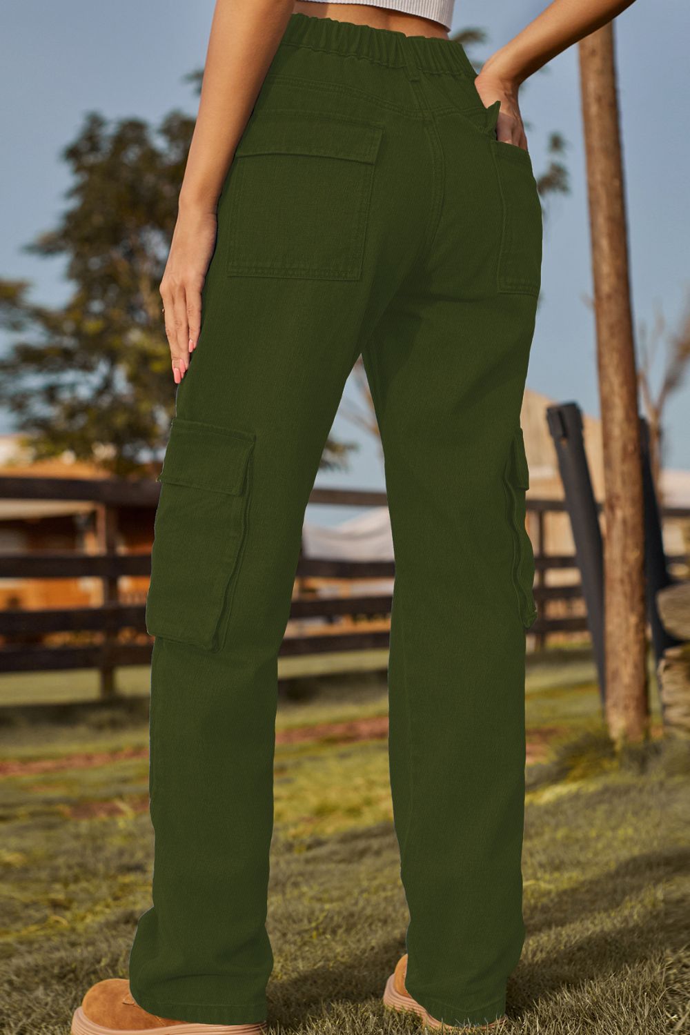 Army green denim cargo pants with multiple utility pockets and a relaxed fit.