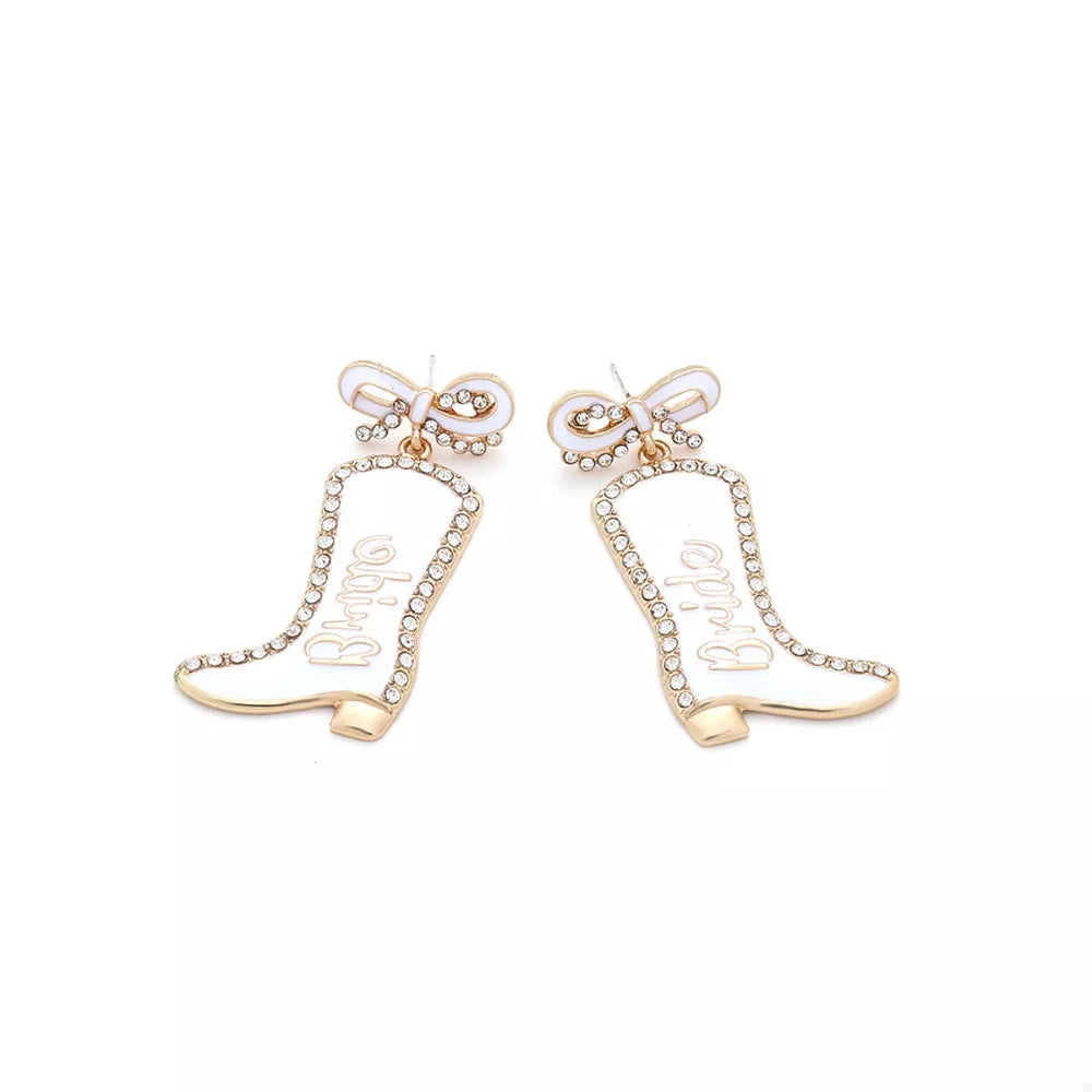 White cowboy boot dangle earrings with "Bride" text, crystal trim, and bow detail.