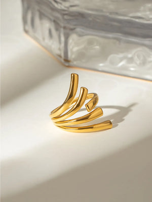 Sculptural spiral ring in gold, 18K gold-plated, modern statement accessory.