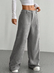 Gray corduroy wide-leg utility trousers with large front pockets and a relaxed fit.