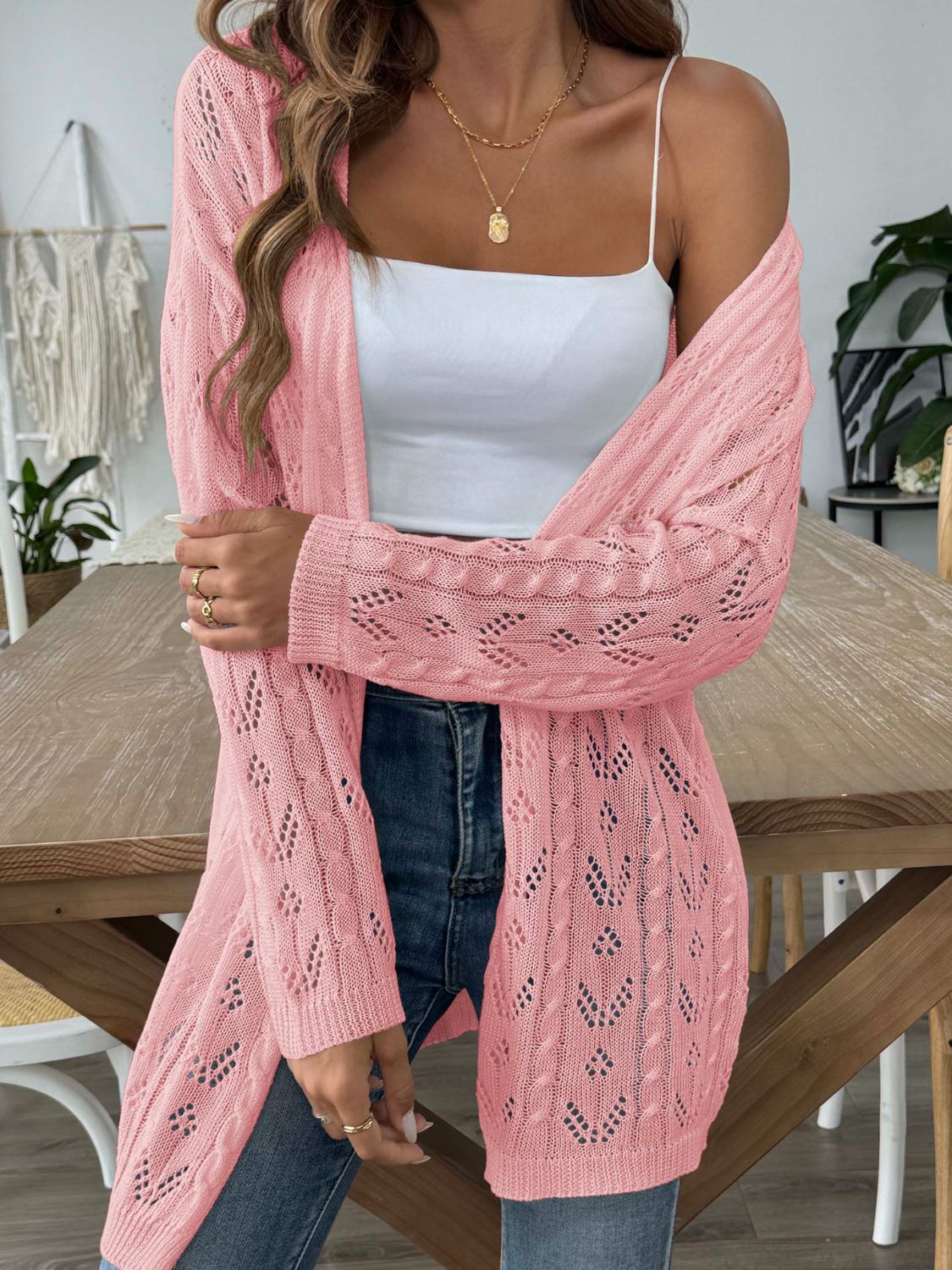 Pink openwork diamond knit duster cardigan with long sleeves and open front.