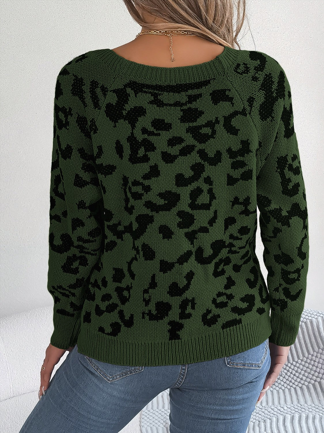 Army green acrylic sweater with black leopard print, crew neck, long sleeves.