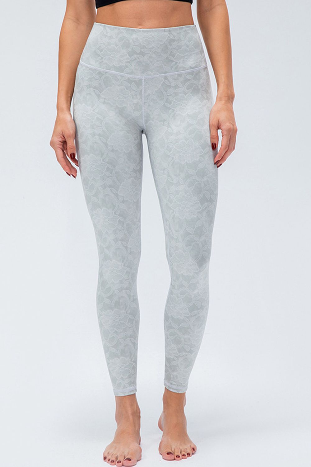 Gray high-rise performance leggings with a subtle lace-like pattern.