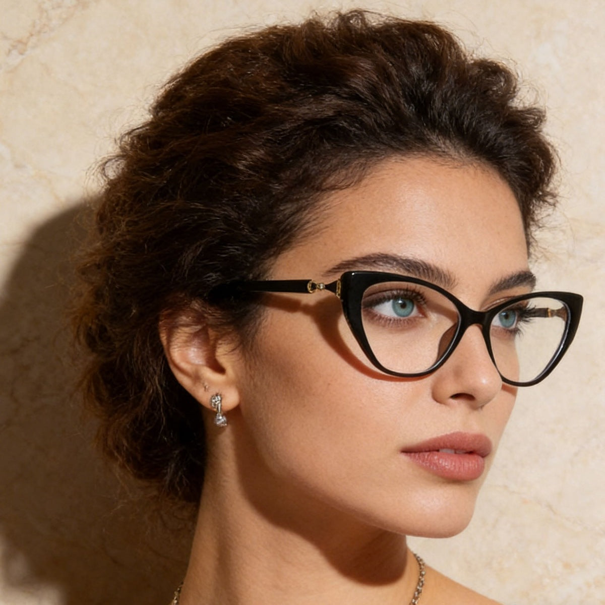 Black cat eye glasses with gold embellishment and clear lenses.