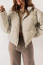Taupe cropped puffer jacket with hood, full zip, and drawstring hem.