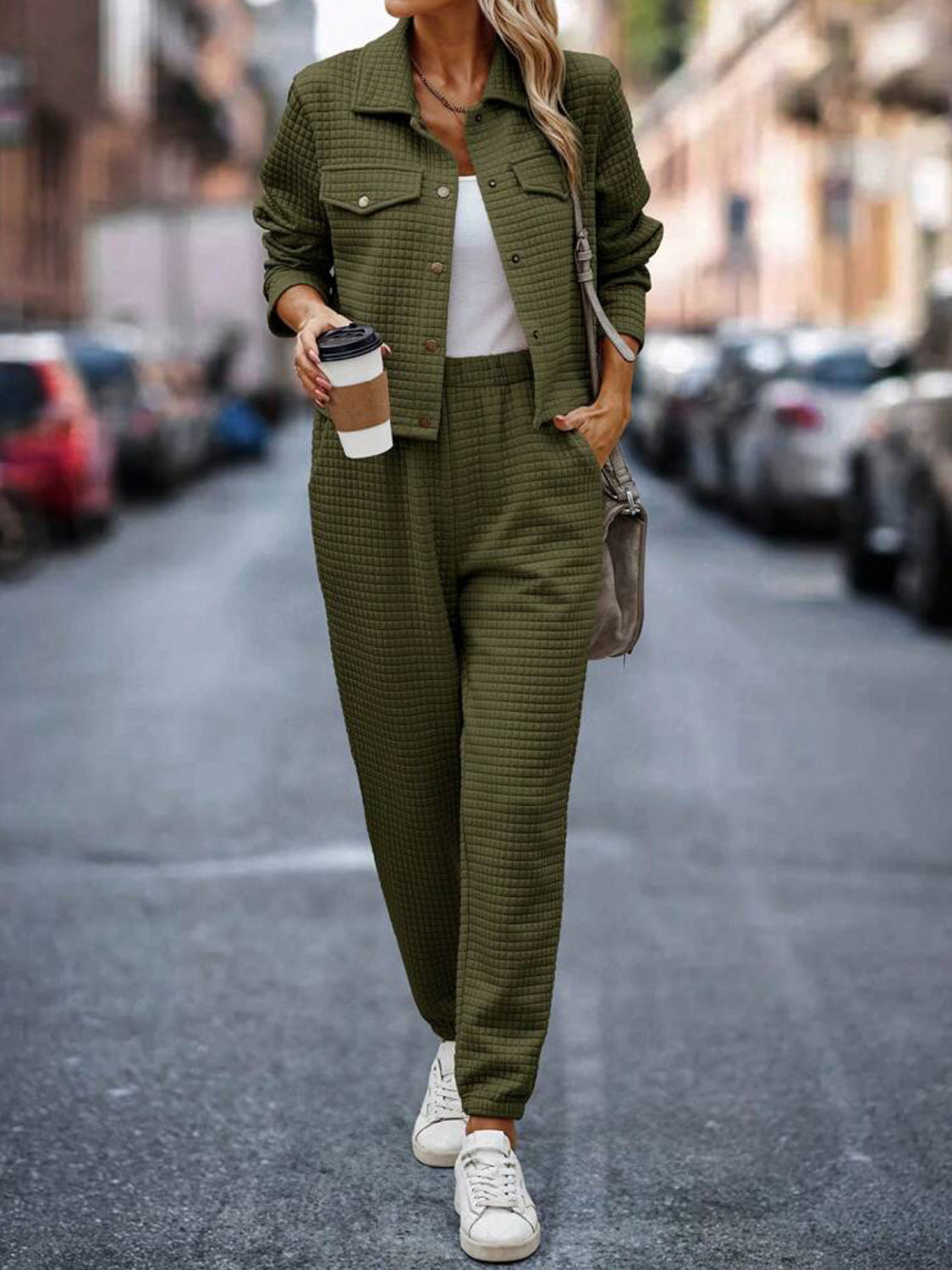 Army green quilted jacket and joggers set with a white top and sneakers.