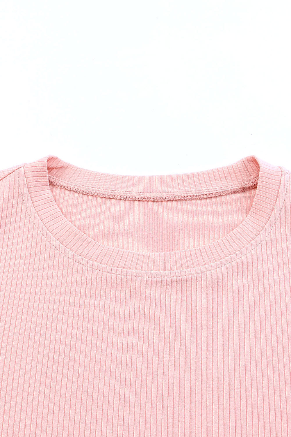 Blush pink ribbed knit blouse with crew neck and visible stitching detail.