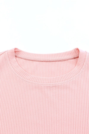 Blush pink ribbed knit blouse with crew neck and visible stitching detail.