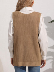 Oversized camel knit vest with ribbed texture and a rounded neckline, styled over a white shirt.