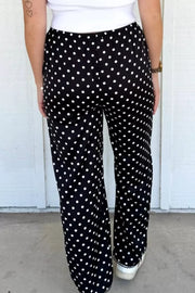 Black polka dot wide-leg maternity trousers with an elastic waistband.