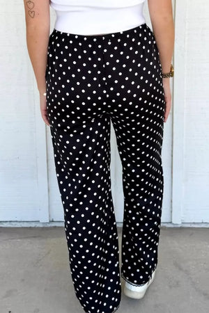 Black polka dot wide-leg maternity trousers with an elastic waistband.