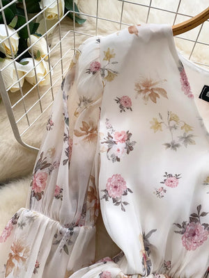 Chiffon floral blouse with balloon sleeves and a V-neck.
