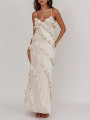 Beige ruffled spaghetti strap maxi dress with diagonal ruffle detailing.