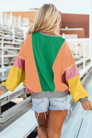 Colorblock paneled sweatshirt with green, tangerine, pink, and yellow blocks and gray trim.