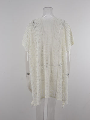 White open-knit V-neck beach cover-up with short sleeves and tassel details.