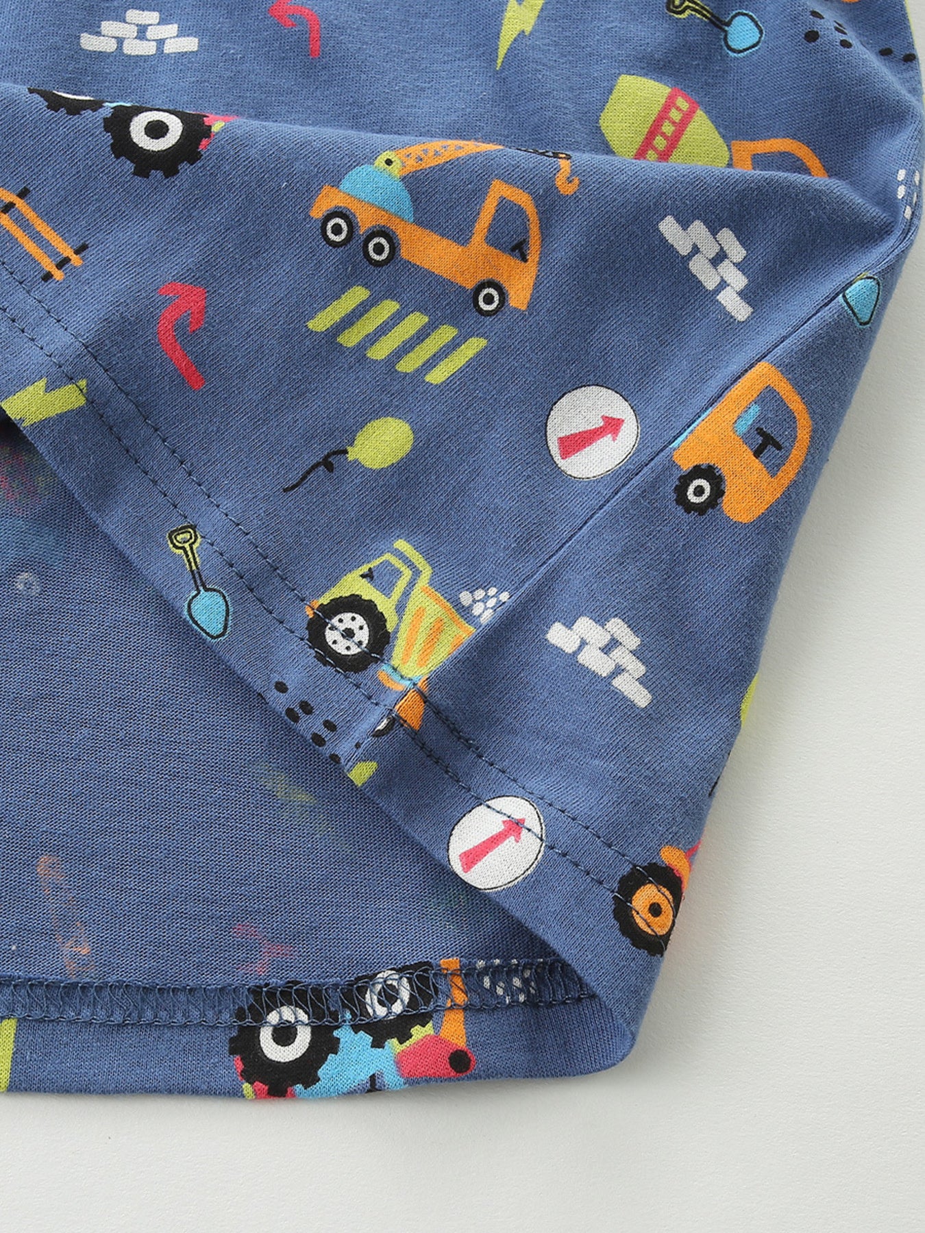 Blue cotton t-shirt with playful construction vehicle print for babies and kids.