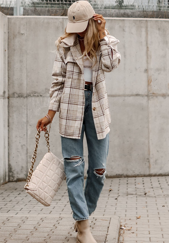 Oversized plaid shacket with attached hoodie, featuring a beige and brown plaid pattern and button front.