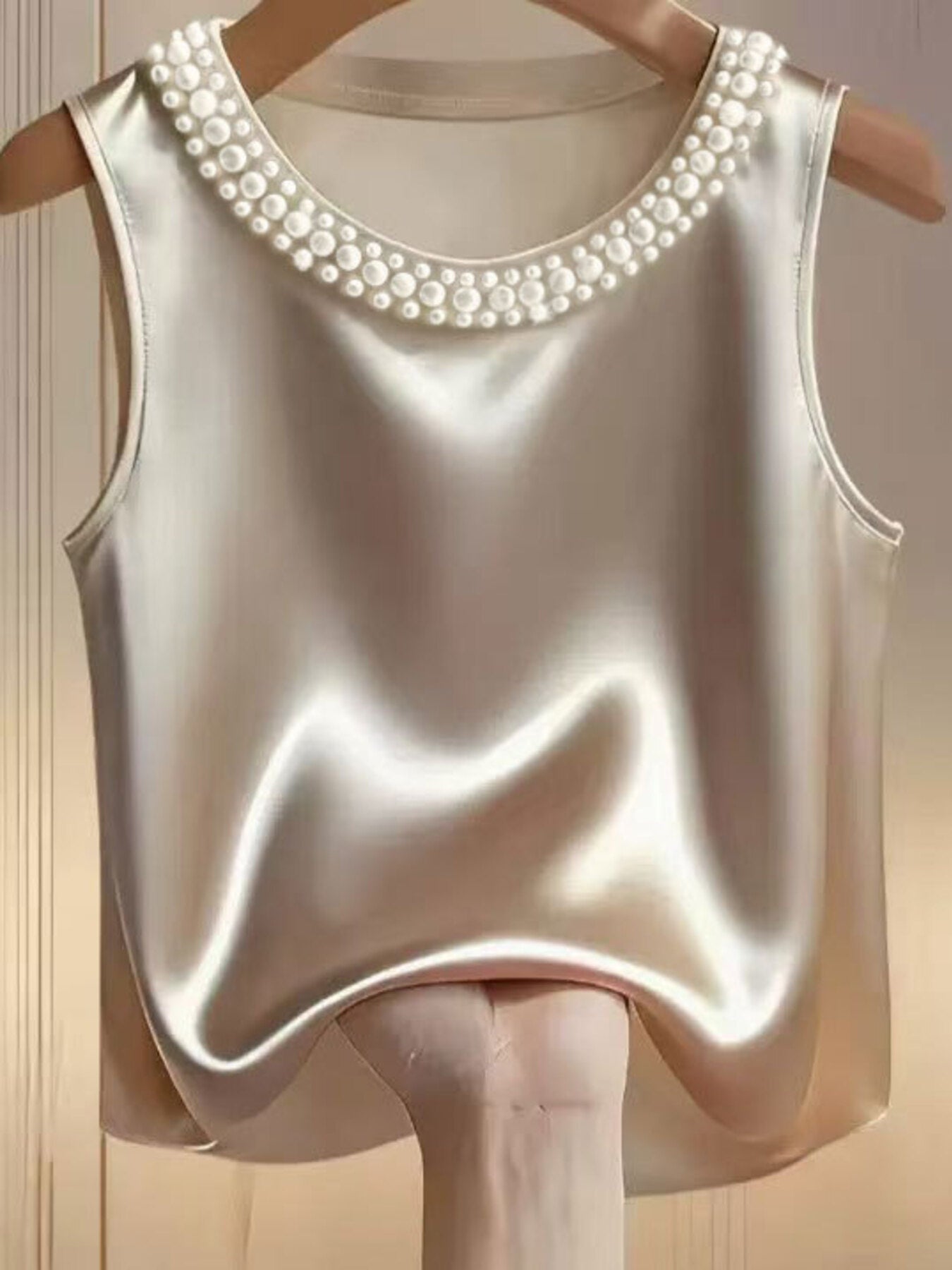 Pearl embellished satin tank top in apricot with round neckline.