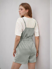 Sage pinstripe romper with adjustable waist, styled with a white t-shirt.