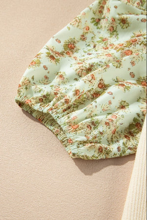 Floral puff sleeve blouse in beige with gathered cuffs and a delicate floral print.