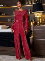 Deep red shimmer jumpsuit with ruffled long sleeves and wide legs.