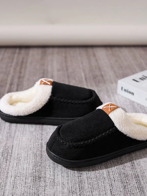 Black suede shearling-lined moccasin slides with contrast stitching and leather detail.