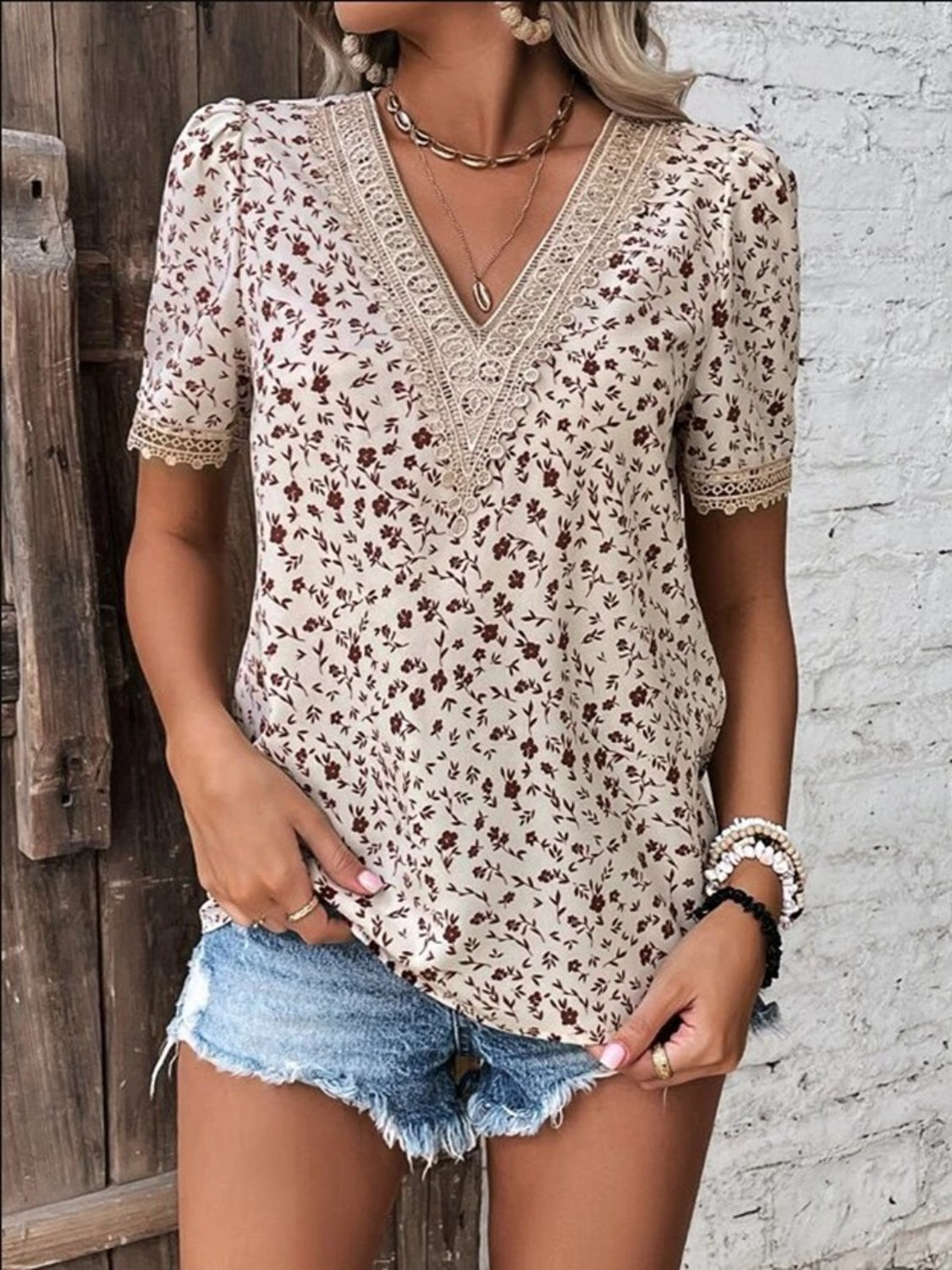 Floral lace trim V-neck blouse in tan with short sleeves and a floral print.