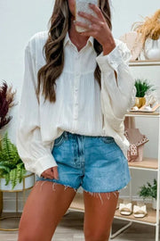 White crinkled texture shirt with button-down front and lantern sleeves.
