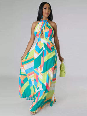 Halter neck maxi dress with bold geometric print, defined waistband, and pleated skirt.