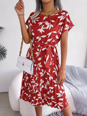 Crimson leaf print midi dress with tie waist and pleated skirt.