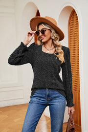 Textured black knit blouse with square neckline and cuffed sleeves.