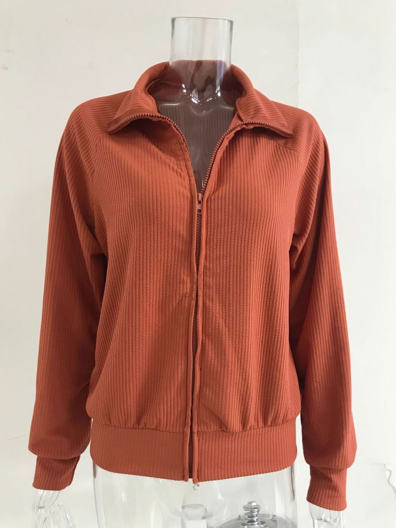 Orange ribbed knit jacket with full zip and collar
