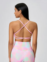 Strappy back active crop top in pink with crisscross straps and a cutout detail.