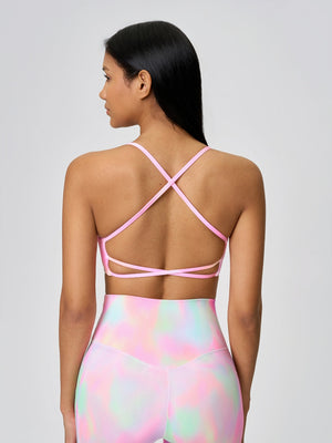 Strappy back active crop top in pink with crisscross straps and a cutout detail.