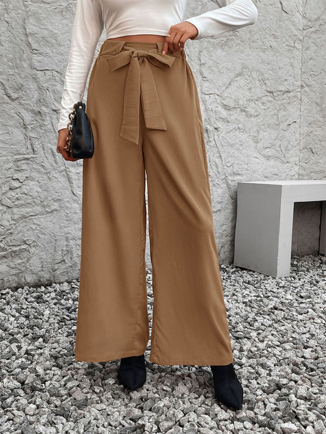 Caramel polyester belted palazzo trousers with a fluid drape and tie waist.