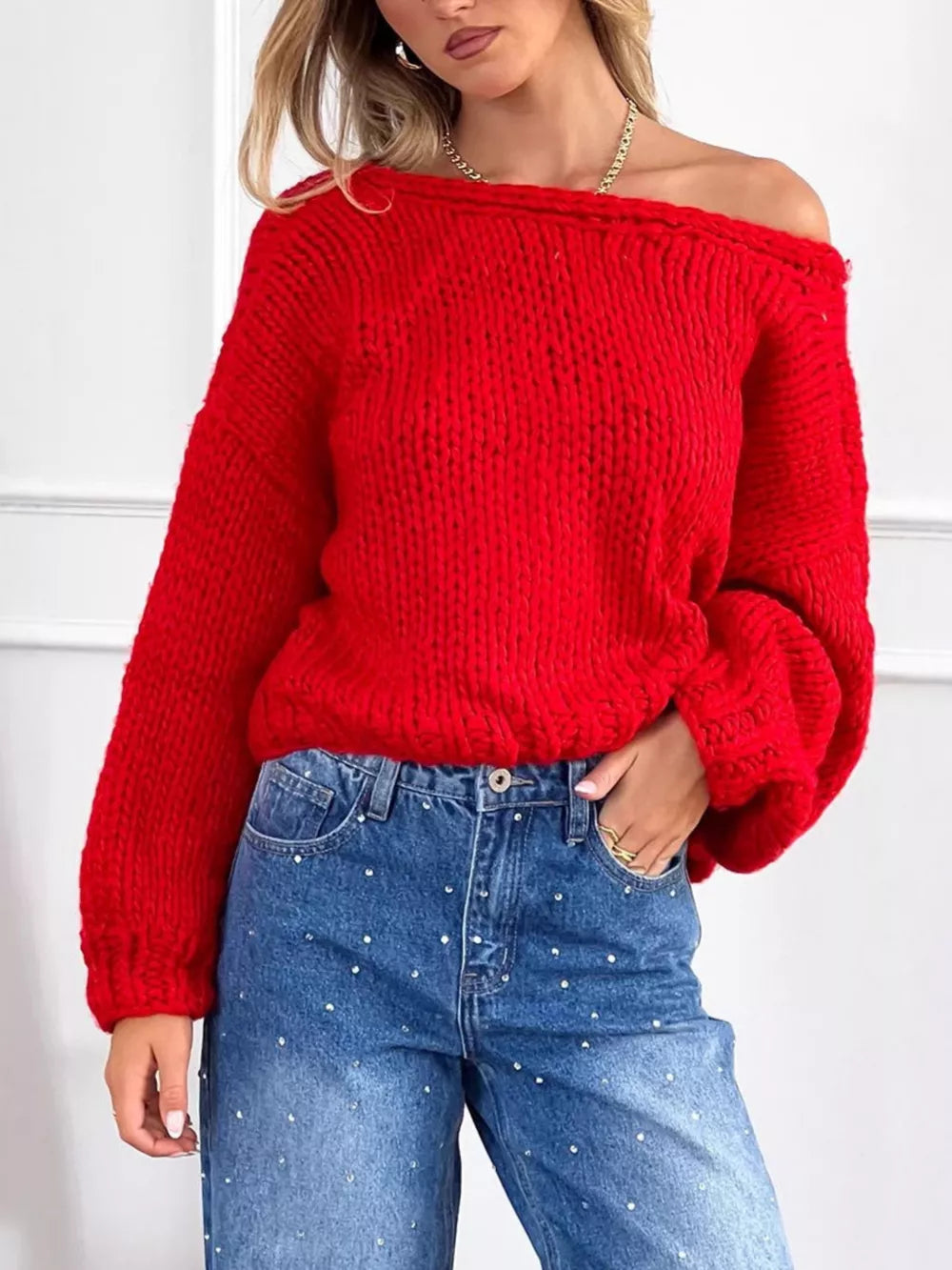 Scarlet off-the-shoulder chunky knit sweater with balloon sleeves, styled with embellished jeans.