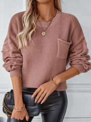 Dusty pink knit sweater with textured sleeves, crew neck, and chest pocket.