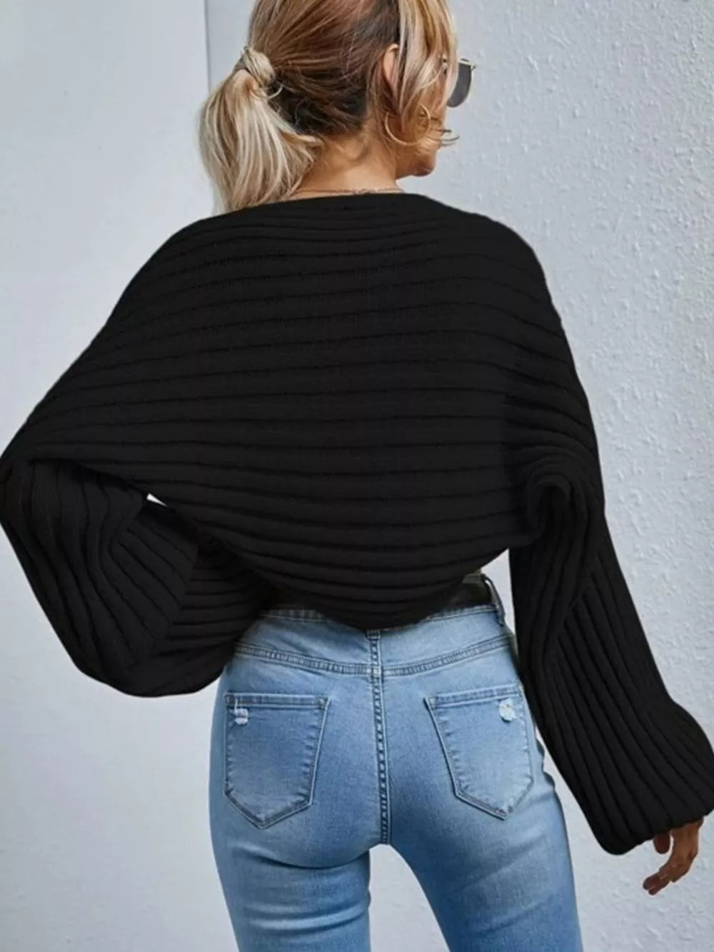Black balloon sleeve cropped knit cardigan with ribbed texture and wide sleeves.
