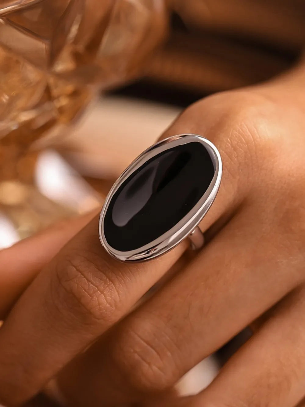 Silver cocktail ring with sculpted oval onyx stone